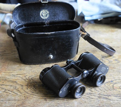 A small optical instrument on a wooden table