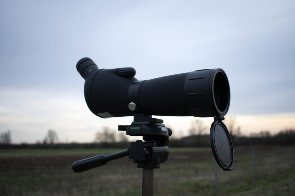 Stargazing or hunting or bird watching spotting scope on a tripod in nature.