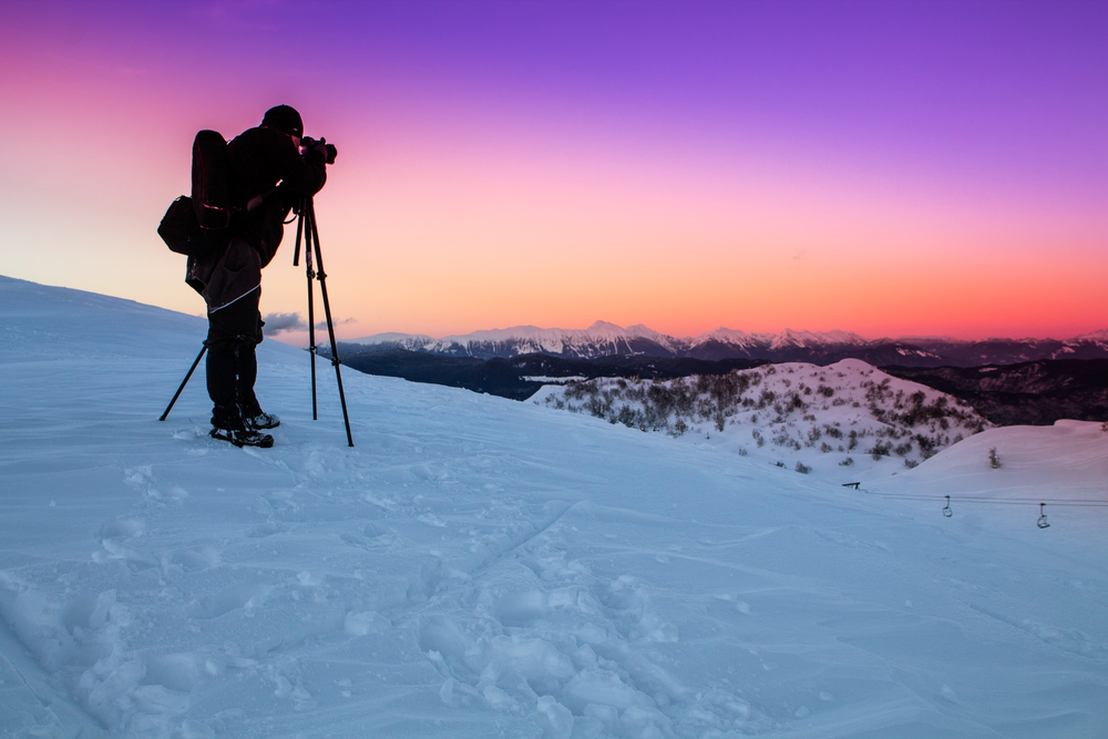 Nature photographer taking photos in the mountains