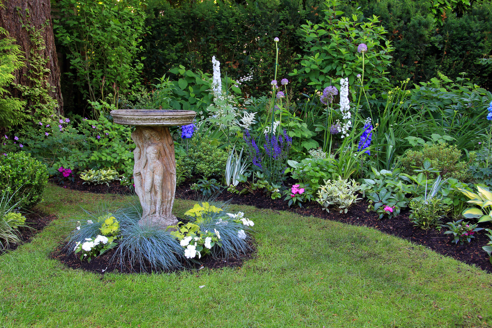 Bird bath in a beautiful summer garden.